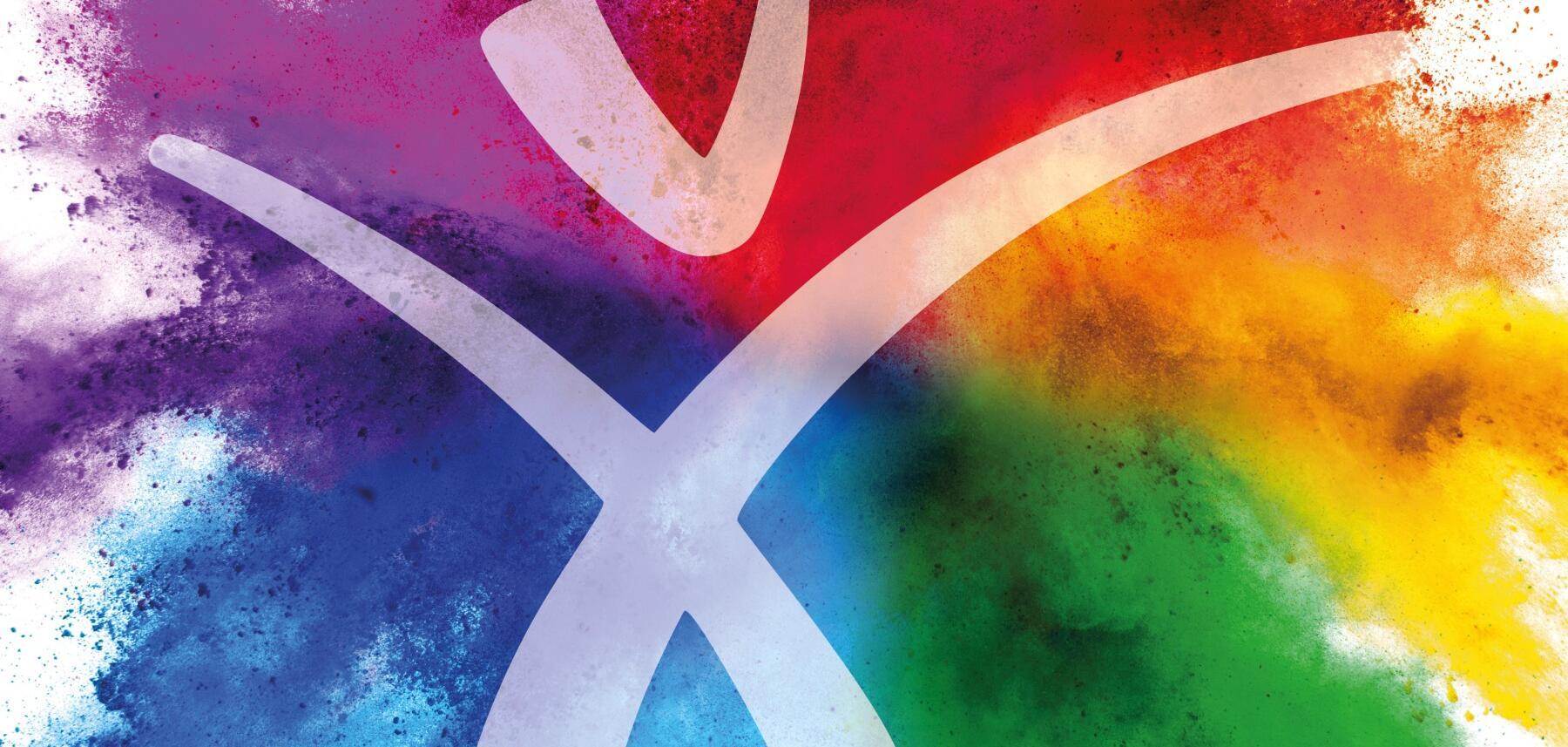Auf Farbklecksen mit den Farben des Regenbogens, angeordnet im Uhrzeigersinn: Rot, Orange, Gelb, Grün, Hellblau, Indigo, Violett, ist das Happy Human durchsichtig-weiß zu sehen.