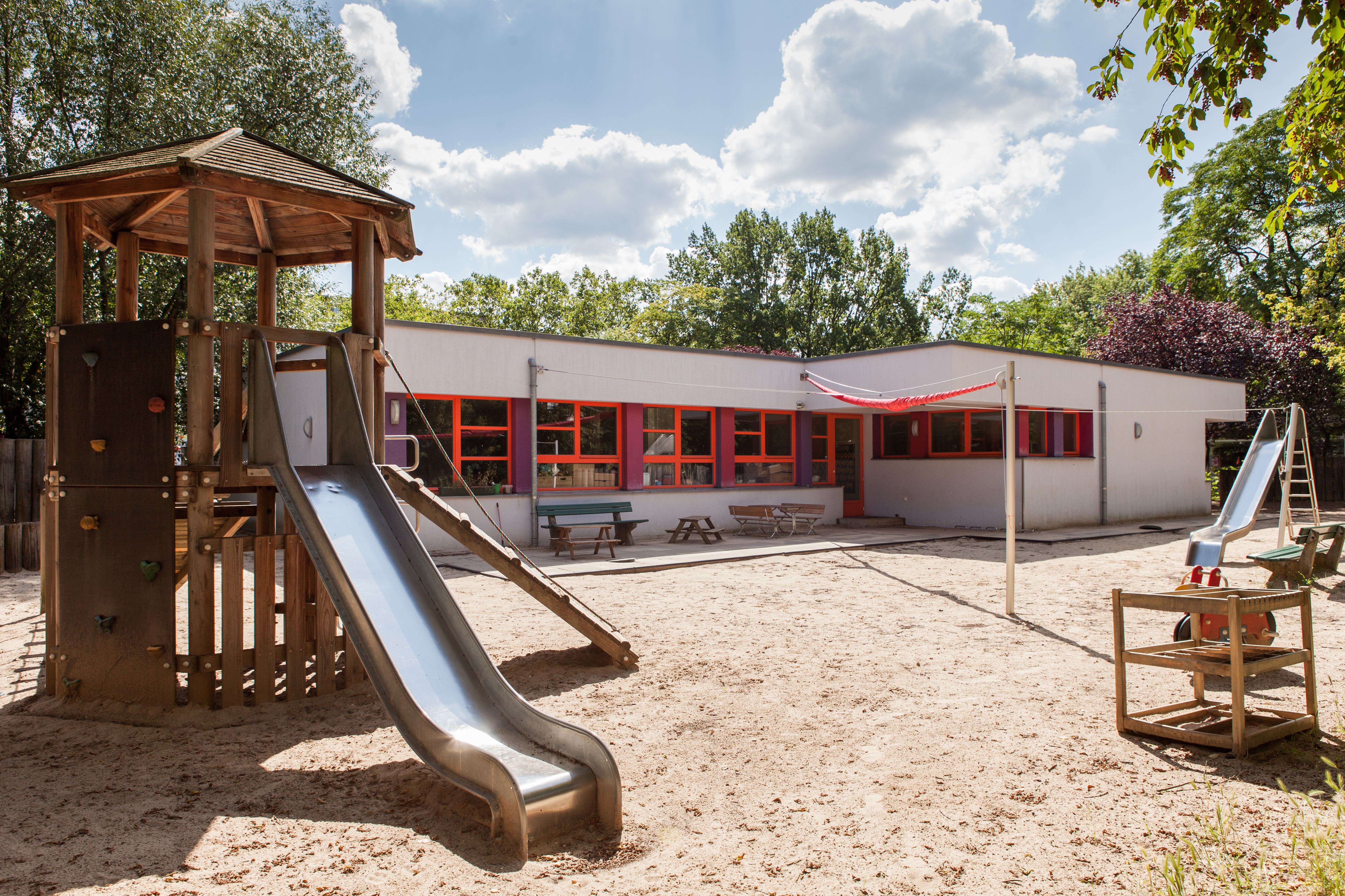 Foto Außenansicht Spielplatz mit Rutsche und Sand Kita General-Woyna-Straße
